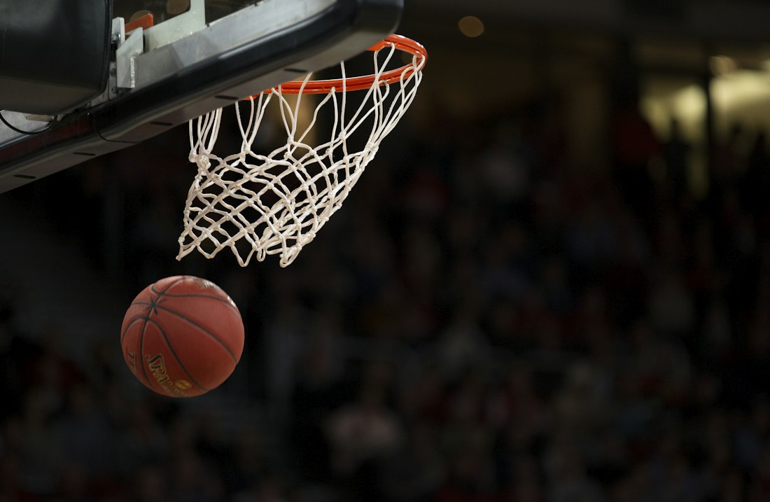 Basketball dropping through the net during a game